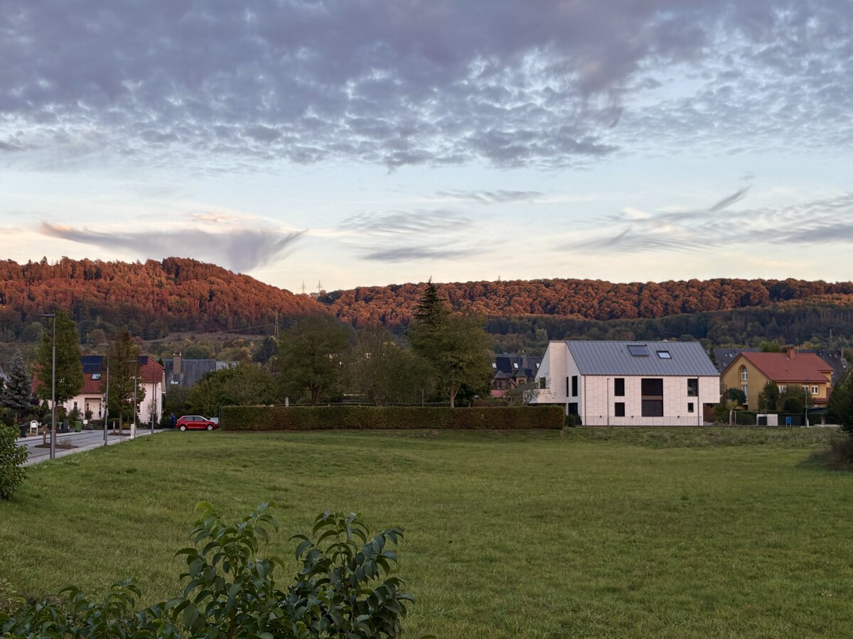 Autumn evening in Walferdange: Glowing hills and uncertain clouds